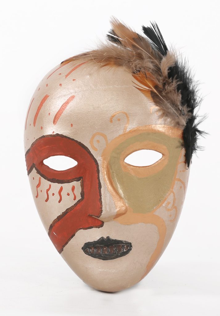 A mask painted in gold, with a traditional opera mask ringing the eyes in scarlet and bronze, and feathers attached to the top left side of the forehead.